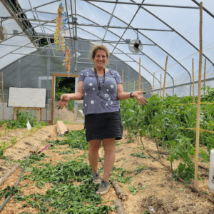 Hudson Valley InterArts instructor Olimpia Bernard inside the Greenhouse of Cultivating Dreams Farm