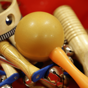 a pile of easy to dance with instruments such as wooden shakers and small tamborines.