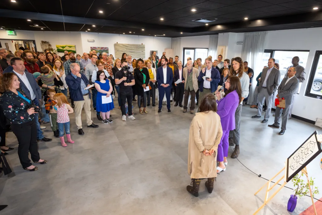 A crowd of visitors, artists, performers and journalists gather for the ribbon cutting ceremony of the Hudson Valley InterArts Center in the great room.
