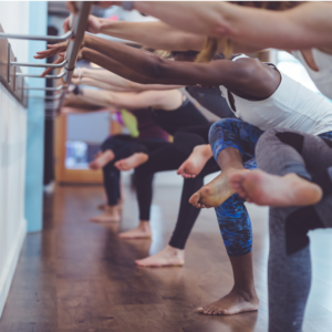 a group of people stretch with the assist of a bar