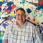 digital arts instructor Jon Harrison smiles for the camera