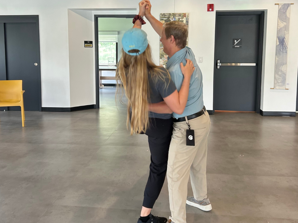 Dance instructor Grace Cotter dances with a student Anthony